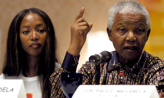 FILE - In this July 30, 2001 file photo, former President of South Africa, Nelson Mandela, right, speaks during a press conference alongside British model Naomi Campbell in Barcelona, Spain, before the 'Frock and Roll' benefit concert to raise money for the Nelson Mandela Children's Fund. Heroic in his deeds, graceful in his manner, sainted in his image, Nelson Mandela long served as both cause and muse in the entertainment community. From the 1960s, when he was a political prisoner and South Africa was under the laws of apartheid, right up to recent times, when the racist laws of the land had fallen and he was among the worlds most admired people, Mandela inspired concerts, songs, poems, fiction and movies.(AP Photo/Cesar Rangel, File)